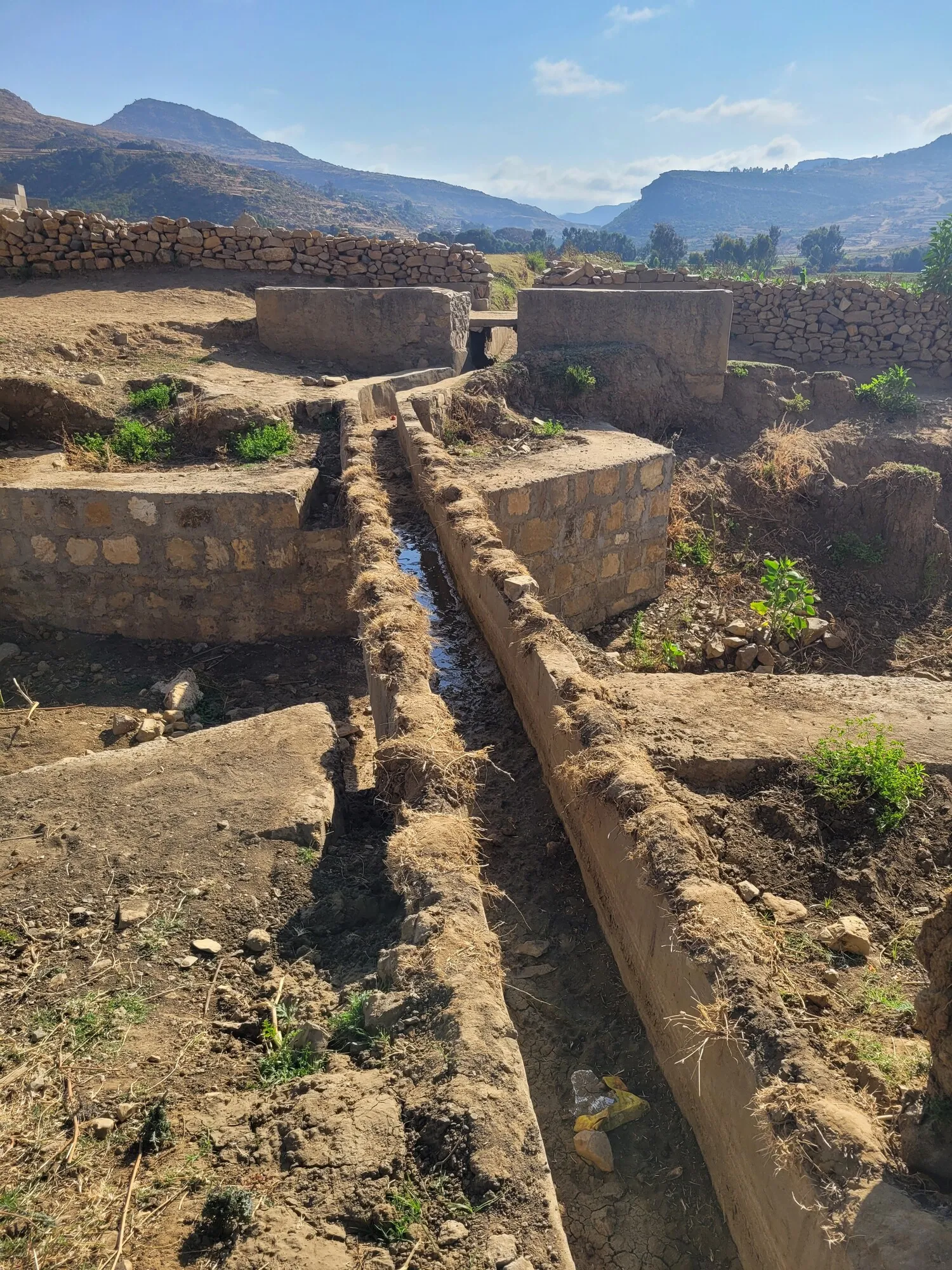 Picture shows a serpentine irrigation channel piercing through a rugged, rocky terrain in Ethiopia.