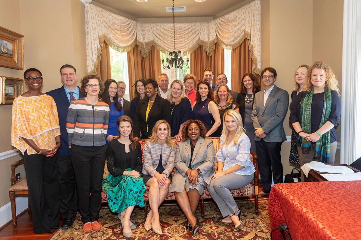 A group of CARE Corporate Council members stand together for a photo.
